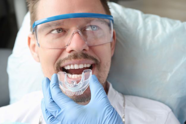 dentist-trying-mouthguard-man-patient.jpg